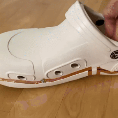 The line of copper tape on this shoe is a circular loop. The copper tape extends to the sole of the shoe after going around the shoe in a circle. The bottom part of the shoe has a battery in contact with one end of the copper tape. The other end is not connected. When pressure is applied to the shoe, the battery contacts the copper tape and lights up.