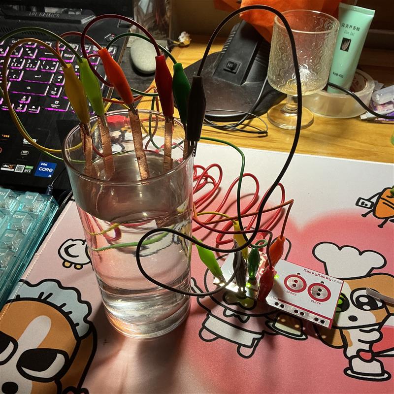 This is me using copper tape on the inside of the glass. When water is poured in and touches the tape, it triggers the button.